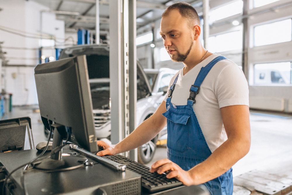 Technician closing out a repair order on a shop floor computer