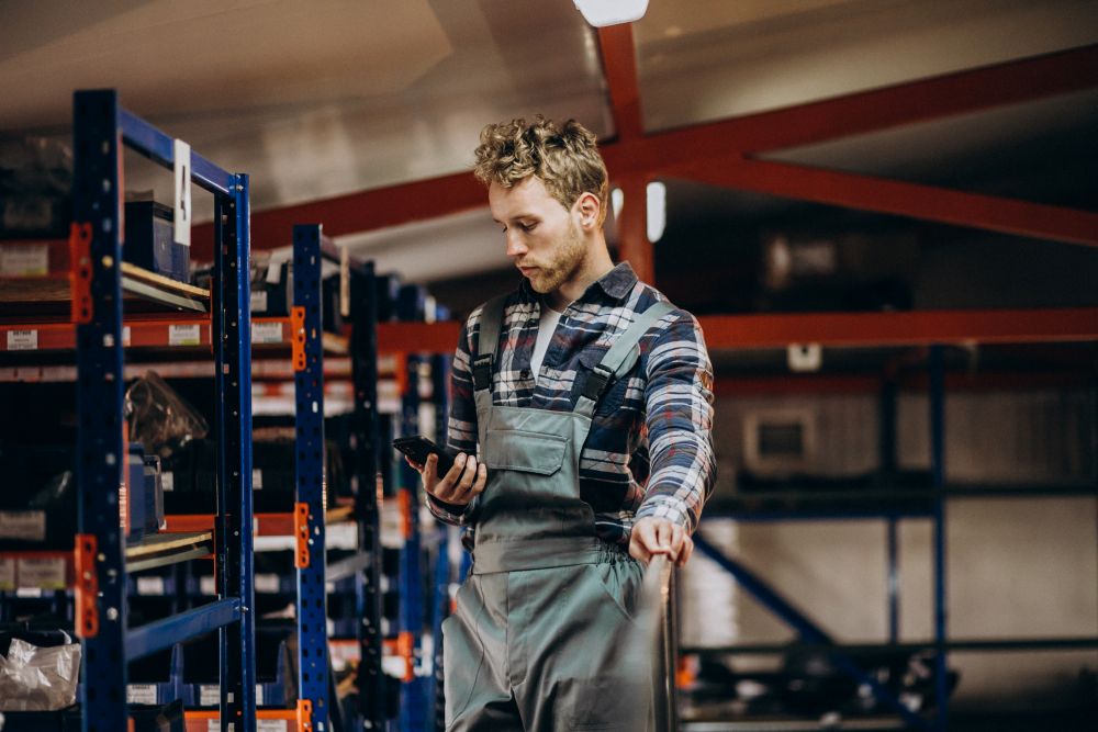 Technician checking parts availability on a shelf in a fleet maintenance shop